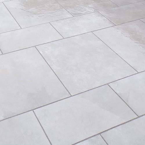 Close up of grey tiles in backyard patio.